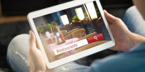 Personne qui cherche un restaurant sur une tablette